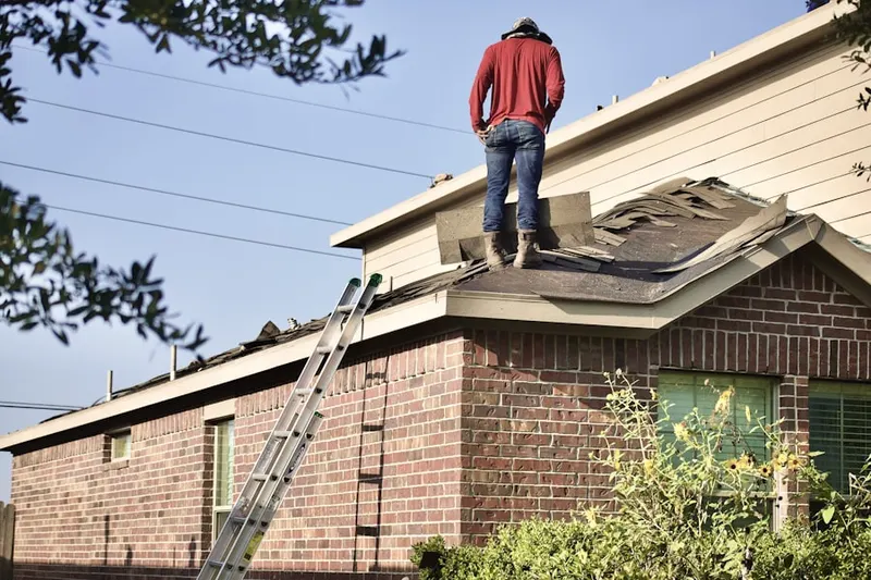Professional roofer working on a residential roof in Englewood South